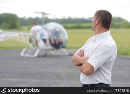 a businessman next to helicopter