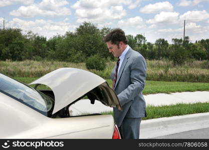 A businessman on a road trip, opening his trunk.
