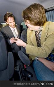 A businessman paying the fare to the taxi driver