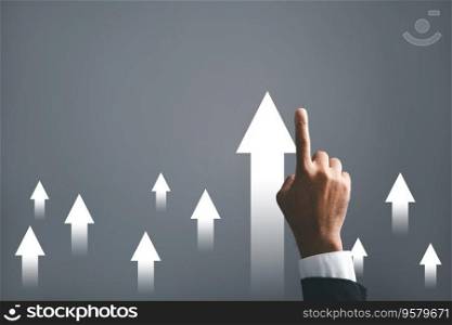 A businessman points an arrow on a graph, portraying the corporate future growth plan. This dynamic image brings to life the concept of business development, growth, and the pursuit of success.