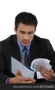 A businessman reading notes.