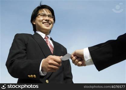 A businessman receiving a business card from his business partner