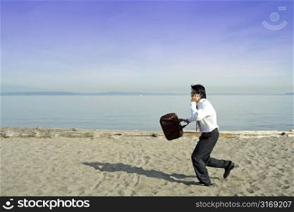 A businessman running and talking on the cell phone in a hurry