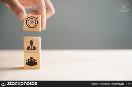 A businessman’s hand meticulously arranges wood blocks in a stacked formation, demonstrating a business strategy and Action plan. This concept represents business development and growth.