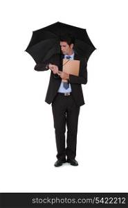 A businessman under an umbrella