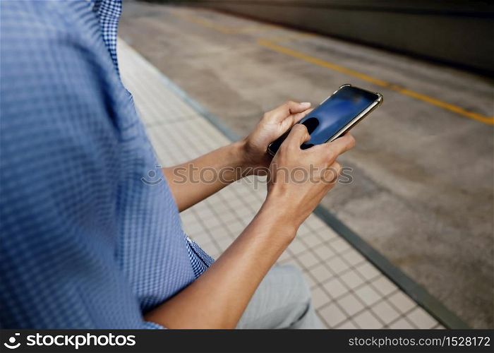 a Businessman Using Mobile Phone in the City. Cropped image, selective focus on Smartphone
