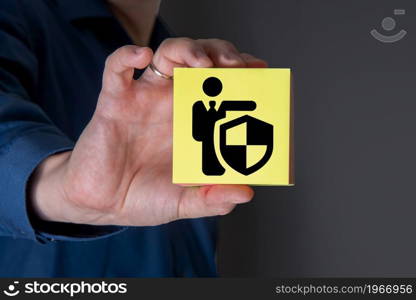 A businessman with a protective gesture and badges of human life insurance. The concept of insurance.. A businessman with a protective gesture and badges of human life insurance.