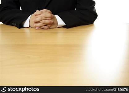 A businessman with hands on a table