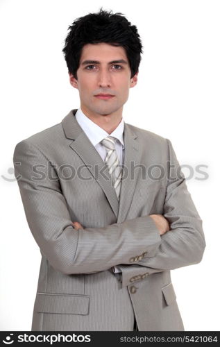 A businessman with his arms crossed.