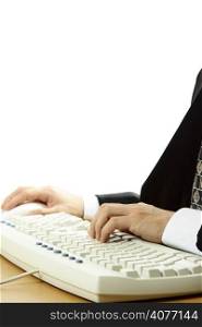 A businessman working and typing on a keyboard