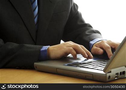 A businessman working and typing on his laptop
