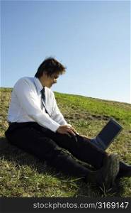 A businessman working on his laptop outdoor