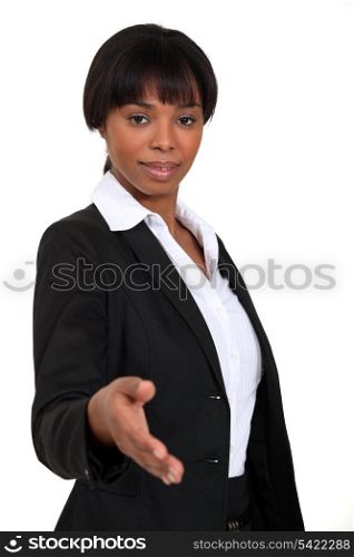A businesswoman about to shake hands.