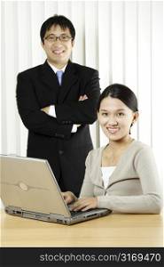 A businesswoman and a businessman in an office