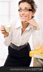A businesswoman drinking coffee, thinking