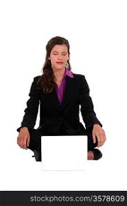 A businesswoman in a lotus position.