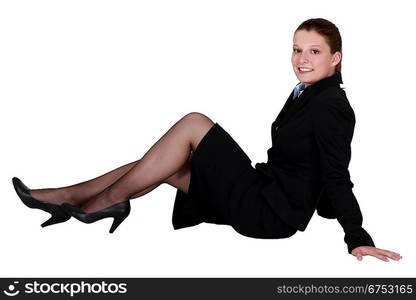 A businesswoman laying on the floor.