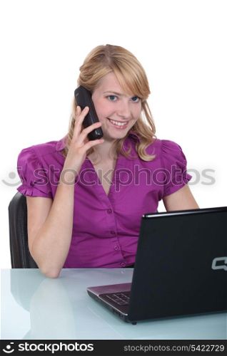 A businesswoman pleased by her phone conversation.