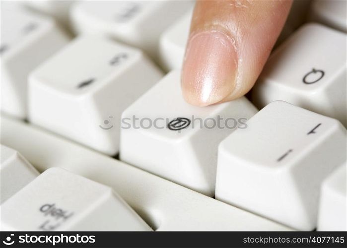 A businesswoman pressing a key on a keyboard