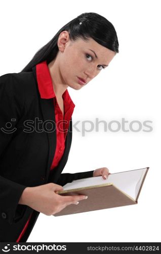 A businesswoman reading a book.