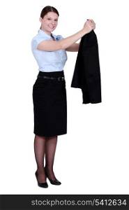 A businesswoman taking off her jacket.