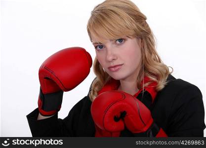 A businesswoman with boxing gloves on.