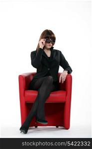 A businesswoman with sunglasses on.