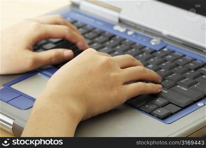 A businesswoman working and typing on her laptop