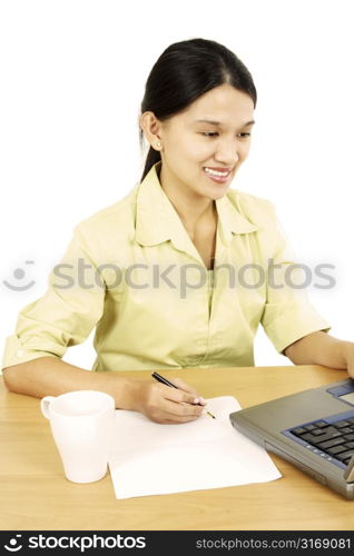 A businesswoman working on her laptop in the office