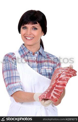 A butcher displaying a cut of meat