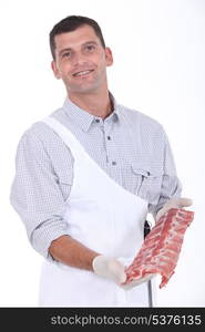 a butcher showing pork ribs