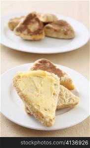 A buttered, traditional, homemade British griddle scone or girdle scone. This kind of scone is popular in Scotland and Wales
