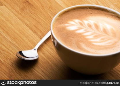 A cafe latte in a bowl with latte art