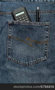 A calculator and pen in a back pocket of a denim jean