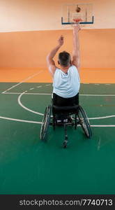 a cameraman with professional equipment records a match of the national team in a wheelchair playing a match in the arena. High quality photo. Selective focus . a cameraman with professional equipment records a match of the national team in a wheelchair playing a match in the arena