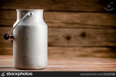 A can of village milk. On a wooden background. High quality photo. A can of village milk.