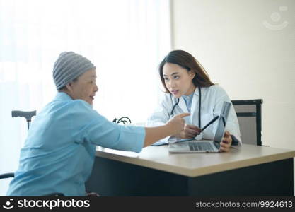 A cancer patient woman wearing head scarf after chemotherapy consulting and visiting doctor in hospital.. Cancer patient woman wearing head scarf after chemotherapy consulting and visiting doctor in hospital.