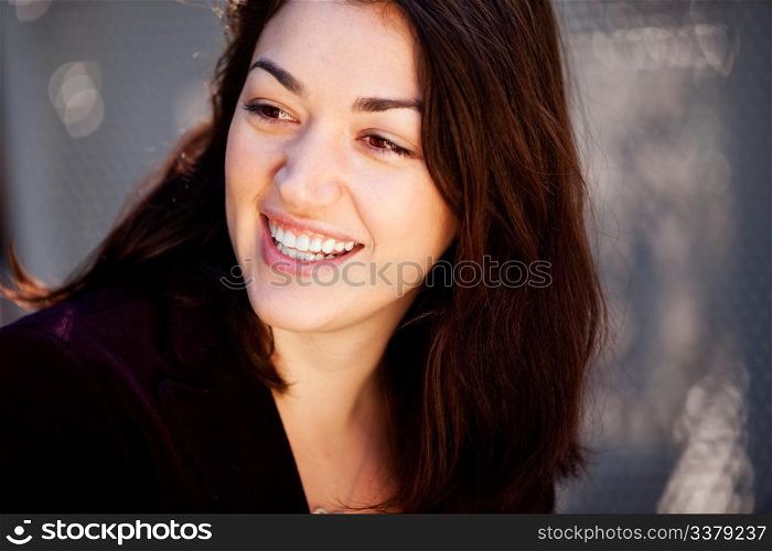 A candid portrait of a happy young woman in an urban setting