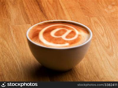 A cappuccino with an @ sybol in the milk