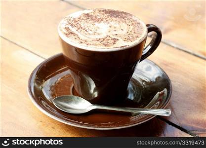 A cappucino on a wooden table