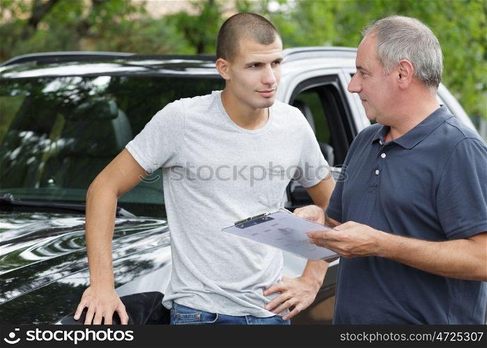 a car dealer holding clipboard