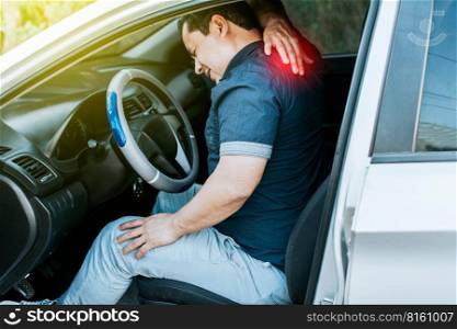 A car driver with muscle pain, concept of a man in his car with neck pain. An exhausted driver with back pain, A person with muscle pain in traffic