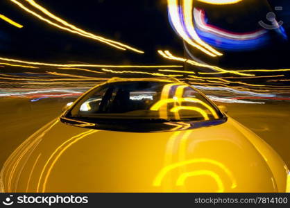 A car taking a turn at night in a downtown environment