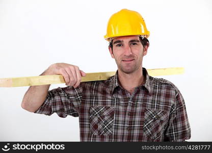 A carpenter carrying a plank.