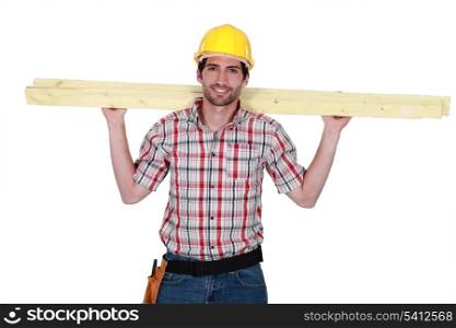 A carpenter carrying planks.