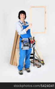 A carpenter holding up her handiwork