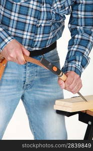 A carpenter using a chisel.