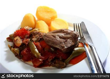 A casserole of lamb&acute;s liver with vegetables, served with boiled potatoes