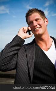A caucasian businessman talking on the phone outdoor