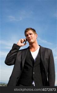 A caucasian businessman talking on the phone outdoor